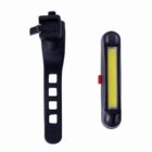 A bicycle tail light set, featuring a rectangular LED light with a yellow strip encased in black and a flexible black rubber mounting strap with multiple holes for adjustment.
