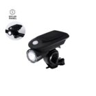 A black bicycle headlight with a solar panel, mounted on a handlebar. The inset shows a close-up of the light glowing. There is a graphic of a lightbulb with Solar Panel text in the corner.