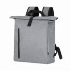 A minimalist gray backpack with a top handle and padded shoulder straps. It has a roll-top closure secured by a black strap and a vertical zippered pocket on the front. The fabric appears textured, offering a modern and sleek design.