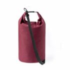 A maroon-colored, cylindrical dry bag with a roll-top closure and a black adjustable shoulder strap, designed for waterproof storage. The bag is upright against a plain white background.