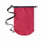 A red, cylindrical dry bag with a black roll-top closure and a clip. It has an attached black strap for carrying. The bag is designed to keep contents dry.