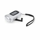 A silver hand crank flashlight with a black wrist strap and built-in solar panel on top. The crank is extended, ready for use, and the flashlight has three visible LED bulbs at the front.