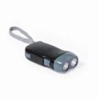 A small black flashlight with two lenses and a gray front casing. It features two side buttons and has a gray wrist strap attached. The flashlight is placed against a white background.