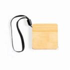 A wooden tape measure with a square body and visible grain patterns. It has a retractable tape and is attached to a black wrist strap. The overall design is simple and minimalist against a white background.
