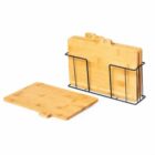 Set of bamboo cutting boards with a black metal holder, one board placed in front.