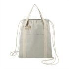 Light beige canvas backpack with drawstring closure and double handles, front pocket visible.