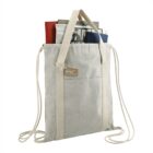Beige canvas tote bag with books and magazines inside, featuring double straps and a pocket.