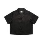 A black, short-sleeved, button-up shirt with a camp collar displayed against a plain white background.