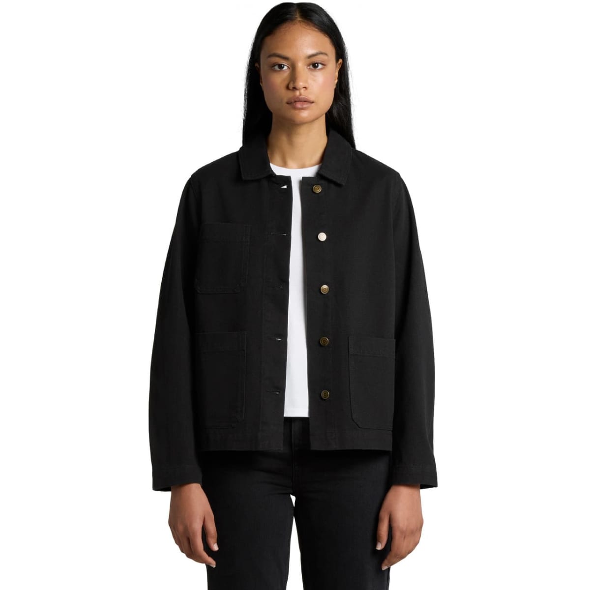 A person with long dark hair wears a black jacket over a white shirt and black pants. The jacket has buttons and pockets, and the person stands against a plain white background.