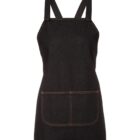 A black denim apron with thick straps and a large front pocket. The stitching is visible around the edges and pocket, adding a subtle design accent. The apron is displayed against a plain white background.