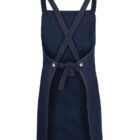 A denim apron with crossed straps in the back and a waist tie. The apron has two brass buttons where the straps attach and a subtle contrast stitching along the edges. The fabric appears durable and suitable for various tasks.