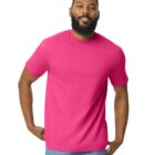 A person with a beard is wearing a bright pink t-shirt and light blue jeans, standing against a plain white background.