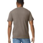 Rear view of a person with short hair wearing a plain olive green T-shirt and blue jeans, standing against a white background.