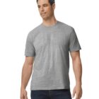 A man wearing a plain gray T-shirt and dark jeans stands against a white background. He has short, dark hair and is looking slightly to the side with a neutral expression.
