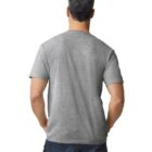 A man with short, gray hair is standing with his back to the camera, wearing a plain gray T-shirt and dark jeans.