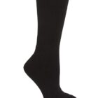 A single black sock is displayed against a white background. The sock is in an upright position, with the heel and toe areas clearly visible.