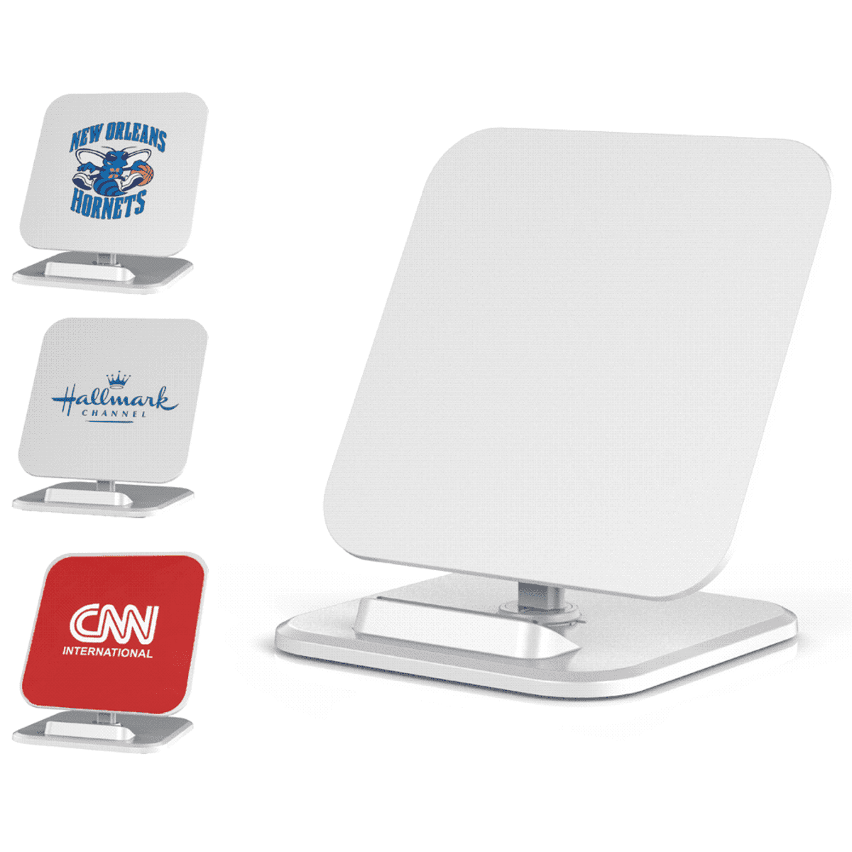 Three white wireless charging pads are displayed. They feature logos from the New Orleans Hornets, Hallmark Channel, and CNN International. Each pad has a minimalist design with a rectangular shape and rounded corners.