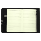 An open notebook with lined pages lies on a black smart notebook cover. A pen is clipped to the right edge. The left flap holds a small electronic device and three cable connectors.