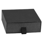 A closed, rectangular black box with a sleek, matte finish. It features a small, black fabric pull tab on one side, suggesting a drawer-like opening mechanism. The box is photographed against a plain white background.