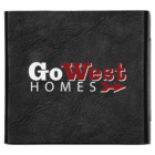 A black binder with the words Go West Homes printed on the cover in white and red lettering. There is a red arrow beneath the word West. The binder has a textured leather-like appearance.