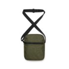 Discover the Flight Two-Tone Bag: a stylish green crossbody with a subtle texture, front zipper pocket, and an adjustable black strap, designed in a chic rectangular shape to blend style and functionality for all your on-the-go adventures.
