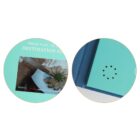 A turquoise gift box with an embedded screen displaying a video of shrimp on a plate. The box cover has a circular cutout with small holes, possibly for speaker output. The text reads Press Play to... on the top left corner of the screen.