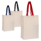 Three beige tote bags are shown, each with different colored handles: blue, black, and red. The bags are displayed in a row, increasing in size from left to right.