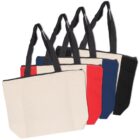 A row of four tote bags with black handles, each with different colored sections: beige and red, beige and blue, beige and black, and all black. They are lined up in a cascading fashion, showing slight side views.