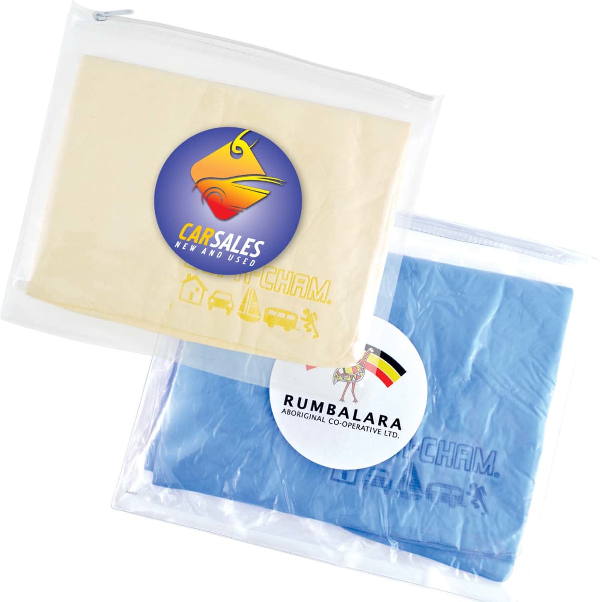 Two ziplock bags with cloths inside, one beige and one blue. The beige bag has a Carsales logo with a stylized bird. The blue bag has a Rumbalara Aboriginal Co-operative logo featuring a multicolored design.