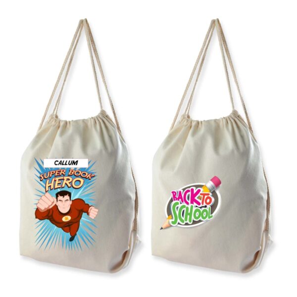 Two light-colored drawstring bags. The first features a superhero design with the text CALLUM SUPER BOOK HERO. The second has a BACK TO SCHOOL graphic with a pencil and eraser.