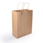 A plain brown paper shopping bag with two twisted paper handles, standing upright on a light-colored surface.