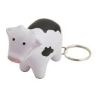 A keychain featuring a small rubber cow figure in black and white. The cow has a simple, stylized design with rounded features and a metal key ring attached to its back.