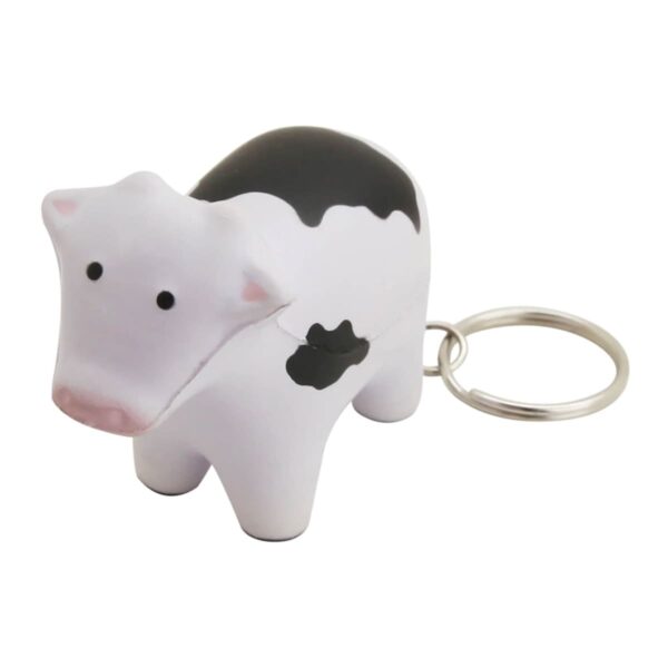 Keychain shaped like a small cow with black and white spots. The cow has a pink muzzle and small, simple eyes. A silver metal ring is attached to the back for keys.