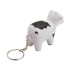 A small, cow-shaped keychain with black and white spots. The cows tail is connected to a silver keyring chain. The keychain is standing on all four legs, and the design is simple and cartoon-like.