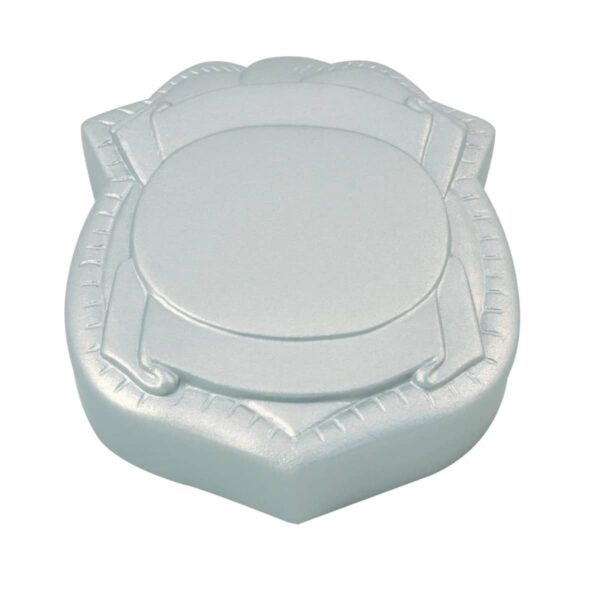 A silver, shield-shaped cake with a central round section. The cake has stylized embossed detailing, giving it a sleek and decorative appearance.