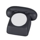 A black stress ball shaped like a classic rotary dial telephone with a white circular area where the dial would be.
