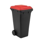 A small toy-like black trash bin with a red lid, featuring two wheels on one side, resembling a miniature version of a typical outdoor garbage can.