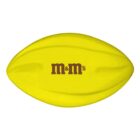 A yellow football-shaped object with m&ms printed in brown letters on its surface.