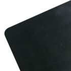 Close-up of a black, textured surface with rounded corners placed against a white background.