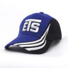 A blue and black baseball cap with ETS in bold white letters on the front. The cap features white curved stripes on the side of the brim.