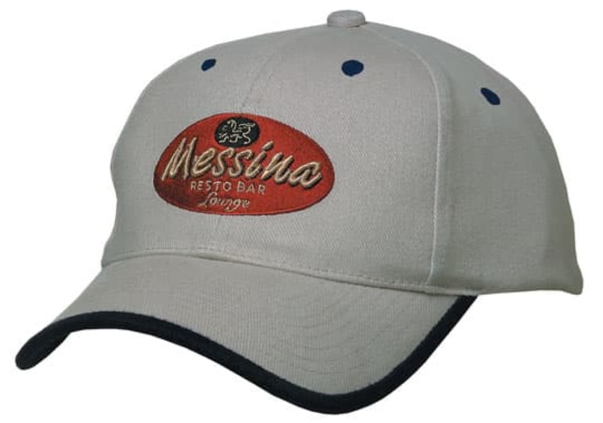 A beige baseball cap with an oval red patch on the front displaying the words Messina Resto Bar Lounge in white cursive font. The cap has a dark brim edge and small dark eyelets on top.