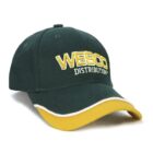A green baseball cap with WESCO DISTRIBUTION embroidered in yellow on the front. The cap features a curved yellow brim with a white trim.