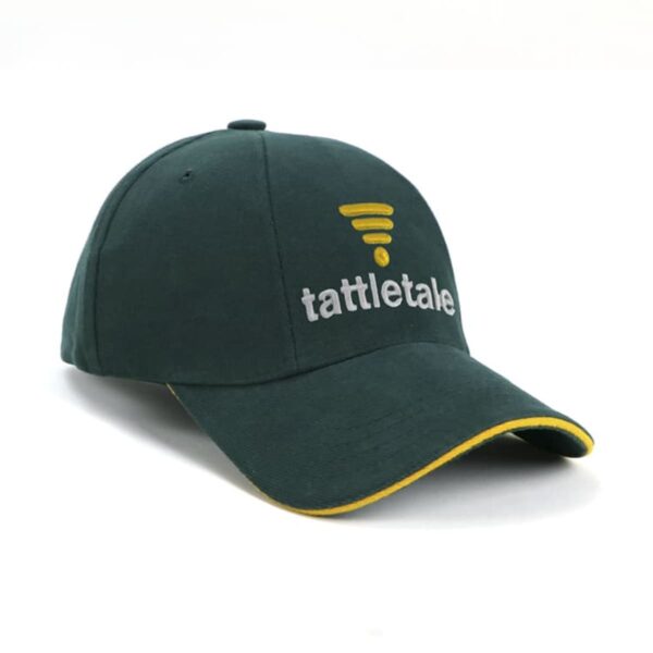 A dark green baseball cap with a yellow emblem and tattletale written in white on the front. The cap features a yellow trim along the brim edge, set against a plain white background.