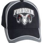 A black and gray baseball cap with FORDHAM embroidered in white letters above a detailed ram head logo. White piping outlines the edges of the cap.
