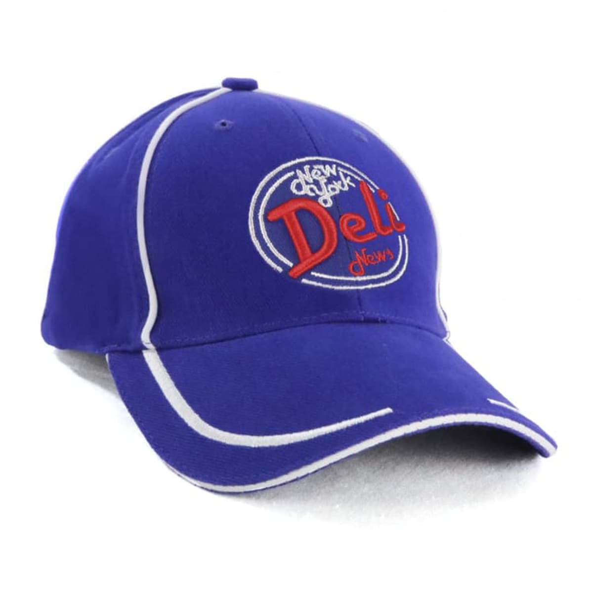 A blue baseball cap with white piping and an embroidered logo on the front that reads New York Deli News in red and white stitching.