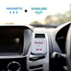 A wireless magnetic phone charger attached to a cars air vent, featuring the text Sutton 15W. The background shows a blurred car dashboard.