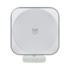 A square wireless charging pad with rounded edges, featuring a magnet icon in the center. The color scheme is light gray and white. The pad has a small connector at the bottom.