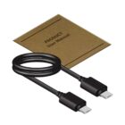 A coiled black USB-C to USB-C cable is placed in front of a brown product user manual. The cable appears new and neatly presented.