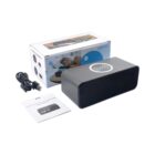 A black rectangular Bluetooth speaker with wireless charging capability is shown alongside a USB cable, a user manual, and its packaging box.