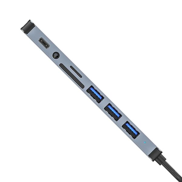 A sleek USB hub with multiple ports, including three USB-A ports, a microSD and SD card slot, an audio jack, and a USB-C port on one side. The device is slim and metallic with a black cable extending from it.